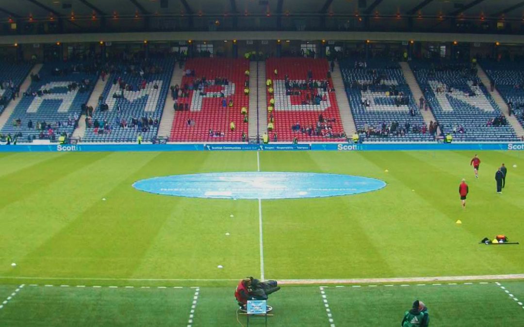The Hampden Stadium with players warming up.