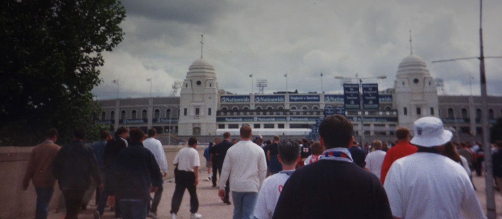 Football fans walking towards the original Wembley stadium.