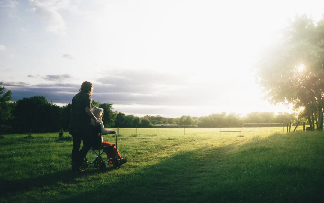 Elderly person out in wheelchair with carer