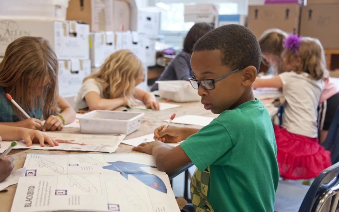 Young school students studying in the classroom